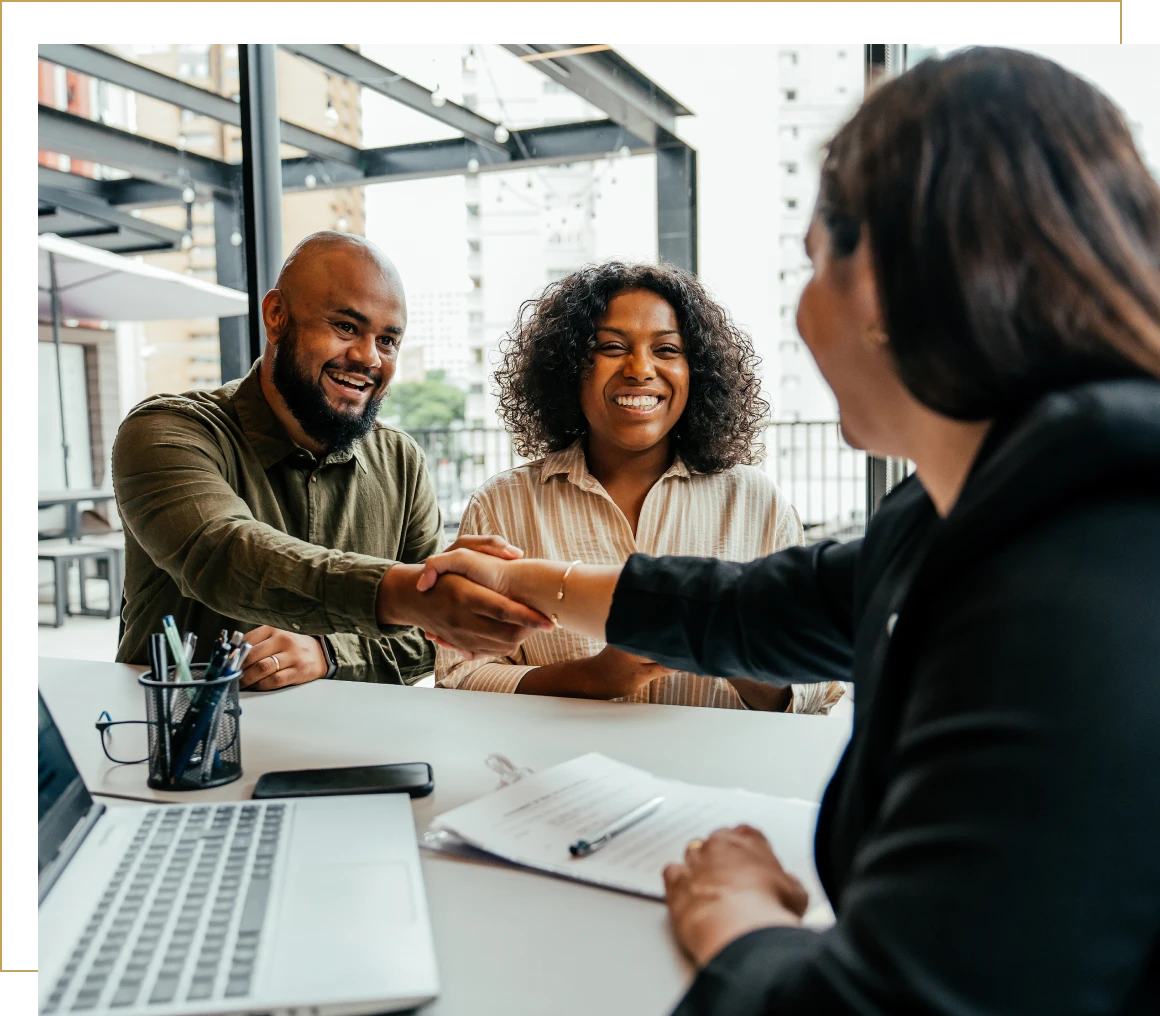 Happy clients shaking hands with consultant