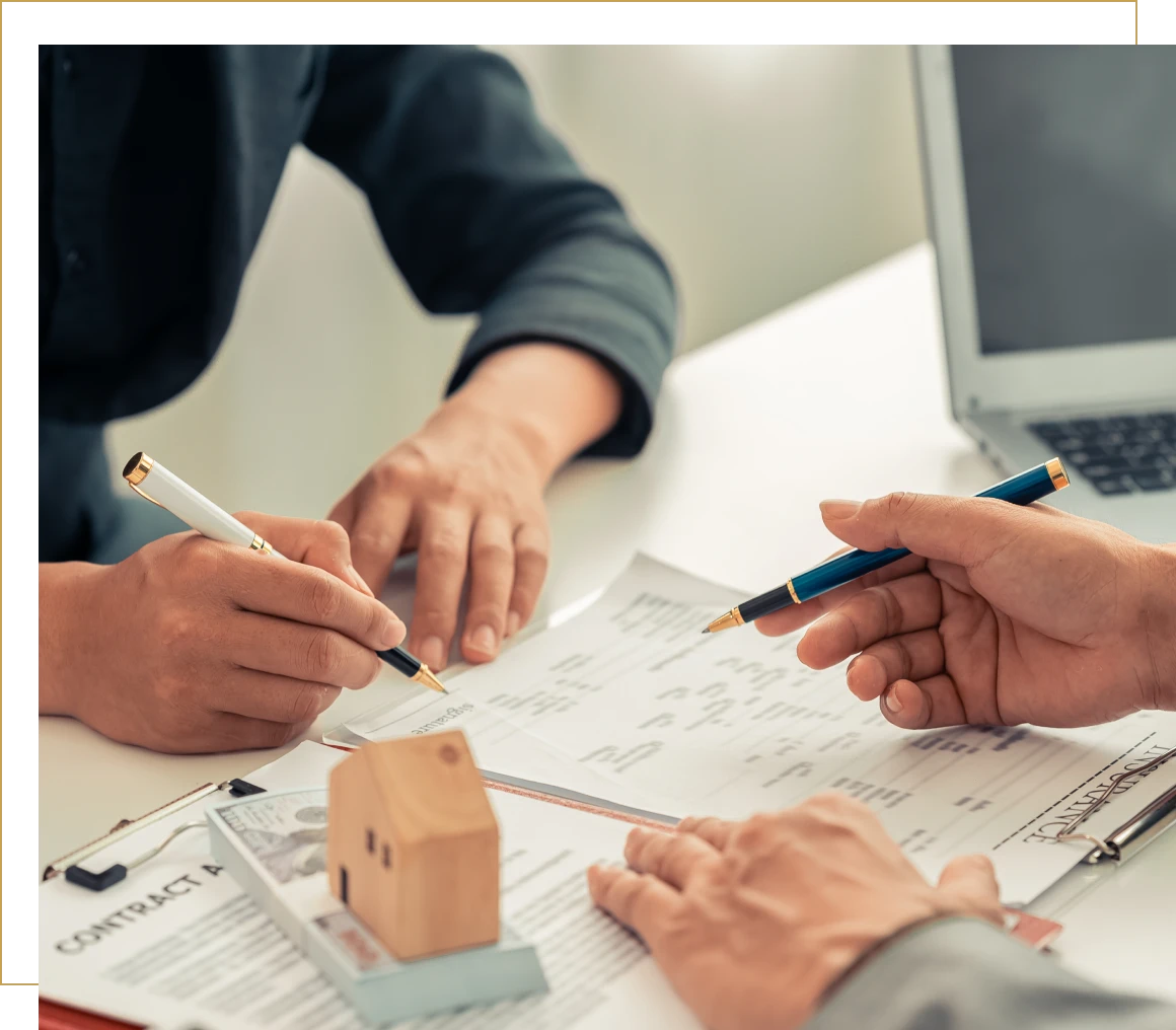 Real estate discussion with documents and pens